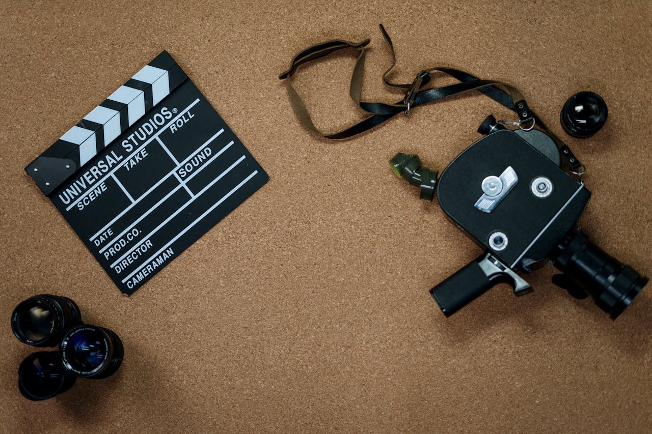 Vintage camera and clapboard on a cork board evoke a classic filmmaking vibe.